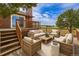Large wooden deck with stylish outdoor furniture and scenic backyard views at 35675 Cheyenne Trl, Elizabeth, CO 80107