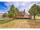 Spacious wooden deck surrounded by mature trees, creating a private and relaxing outdoor living area at 35675 Cheyenne Trl, Elizabeth, CO 80107