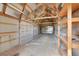 Large barn interior with wood beams, corrugated metal ceiling, and concrete floor, perfect for storage or workshop at 35675 Cheyenne Trl, Elizabeth, CO 80107