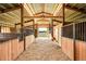 Spacious barn interior with horse stalls, offering ample room for livestock at 35675 Cheyenne Trl, Elizabeth, CO 80107