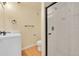 Bathroom with a glass-enclosed tiled shower, toilet, vanity, and bronze hardware at 35675 Cheyenne Trl, Elizabeth, CO 80107