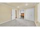Carpeted bedroom features an open doorway, built-in desk, and ample closet space at 35675 Cheyenne Trl, Elizabeth, CO 80107