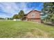 Charming home with lush lawn and mature trees offering a tranquil curb appeal and inviting entrance at 35675 Cheyenne Trl, Elizabeth, CO 80107