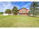 Charming home with lush lawn and mature trees offering a tranquil curb appeal and inviting entrance at 35675 Cheyenne Trl, Elizabeth, CO 80107