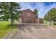 Angle view of home and two-car garage with grass and driveway at 35675 Cheyenne Trl, Elizabeth, CO 80107