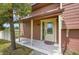 Inviting front porch with a decorative door and a 'Welcome' mat, enhanced by a mature tree at 35675 Cheyenne Trl, Elizabeth, CO 80107
