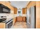 Kitchen with stainless steel appliances, marble counters and light wood cabinets at 35675 Cheyenne Trl, Elizabeth, CO 80107