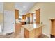 Galley kitchen offering an extended marble countertop and wood cabinets at 35675 Cheyenne Trl, Elizabeth, CO 80107