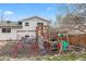 Outdoor playset in backyard, featuring swings, slide and climbing dome at 217 Douglas Fir Ave, Castle Rock, CO 80104