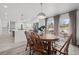 Bright dining room with wood floors, a classic table set, and sliding doors leading to the outdoors at 217 Douglas Fir Ave, Castle Rock, CO 80104