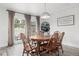 Cozy dining area with wood floors, a round table, and a view of the backyard through large windows at 217 Douglas Fir Ave, Castle Rock, CO 80104