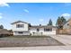 Charming, updated home with a well-manicured lawn and lovely curb appeal on a sunny day at 217 Douglas Fir Ave, Castle Rock, CO 80104