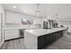Bright, newly renovated kitchen with a large island, stainless steel appliances, and modern lighting at 217 Douglas Fir Ave, Castle Rock, CO 80104