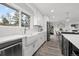 Modern kitchen with white cabinets, stainless steel appliances, a large sink, and stylish fixtures at 217 Douglas Fir Ave, Castle Rock, CO 80104