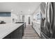 Open kitchen with a large island, stainless steel appliances, and a sleek design, perfect for cooking at 217 Douglas Fir Ave, Castle Rock, CO 80104