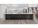 The renovated kitchen has white cabinets, a large center island, modern pendant lights, and stainless steel appliances at 217 Douglas Fir Ave, Castle Rock, CO 80104