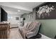 Comfortable living space with a gray futon, blanket, and floral wall art, creating a welcoming ambiance at 217 Douglas Fir Ave, Castle Rock, CO 80104