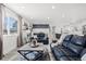 Open-concept living space with comfortable seating and a modern kitchen at 217 Douglas Fir Ave, Castle Rock, CO 80104