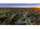 Beautiful community featuring attractive homes, lush greenery, and picturesque mountain views at sunset at 7083 Winthrop Cir, Castle Rock, CO 80104