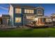 Two-story home with a large backyard featuring a deck with an outdoor dining area at 7083 Winthrop Cir, Castle Rock, CO 80104