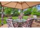 A backyard patio is set up with a table and chairs, under a gazebo at 7083 Winthrop Cir, Castle Rock, CO 80104