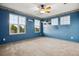 The bedroom is painted blue and has three windows that let in lots of natural light at 7083 Winthrop Cir, Castle Rock, CO 80104