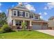 Lovely two-story home with well-manicured front lawn, landscaping, and attached three-car garage at 7083 Winthrop Cir, Castle Rock, CO 80104