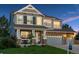 Attractive two-story home with a stone facade, well-kept lawn, and a three-car garage at 7083 Winthrop Cir, Castle Rock, CO 80104
