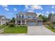 Beautiful two-story home featuring a well-manicured front lawn and an attached three-car garage at 7083 Winthrop Cir, Castle Rock, CO 80104