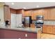 Modern kitchen featuring granite countertops, stainless steel appliances, and wood cabinetry at 7083 Winthrop Cir, Castle Rock, CO 80104