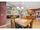 Open-concept space with dining area flowing into a living room with a fireplace and upper-level view at 7083 Winthrop Cir, Castle Rock, CO 80104