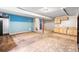 Spacious basement area with tile flooring, a wet bar, and potential for customization at 21354 E 51St Ave, Denver, CO 80249