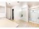 Bright bathroom features a soaking tub, walk-in shower, and a neutral color palette at 21354 E 51St Ave, Denver, CO 80249