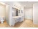 Bathroom with a double vanity and large mirror. An adjacent toilet room increases privacy at 21354 E 51St Ave, Denver, CO 80249