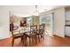 Light and airy dining room with glass table and seating for six and sliders to the backyard at 21354 E 51St Ave, Denver, CO 80249