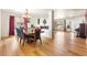 Dining room with hardwood floors, chandelier, large window, and views to front living room at 21354 E 51St Ave, Denver, CO 80249