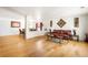 Open-concept living room and dining area with hardwood floors, decorative art and comfortable seating at 21354 E 51St Ave, Denver, CO 80249