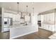 Modern kitchen featuring white cabinets, stainless steel appliances, and quartz countertops at 12639 Lake Terrace St, Firestone, CO 80504