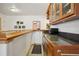 A well appointed wet bar featuring wooden cabinets and a dark countertop at 20190 Deer Shadow Way, Monument, CO 80132
