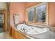 Relaxing bathtub with jets, next to a window with views and a glass enclosed shower in the background at 20190 Deer Shadow Way, Monument, CO 80132