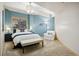 Relaxing bedroom featuring a comfortable bed, accent chair, and serene blue walls at 20190 Deer Shadow Way, Monument, CO 80132