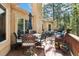 Spacious deck with an outdoor dining set, additional seating, and views of the surrounding trees at 20190 Deer Shadow Way, Monument, CO 80132