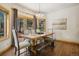 Bright dining room with hardwood floors, wooden table, and sliding doors to the backyard at 20190 Deer Shadow Way, Monument, CO 80132