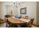 Elegant dining room with a modern chandelier, a large mirror, and a wooden table with seating for six at 20190 Deer Shadow Way, Monument, CO 80132
