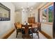 Formal dining room with a wooden table and a bright window showing the backyard at 20190 Deer Shadow Way, Monument, CO 80132