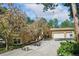 Home exterior featuring beautiful flowering trees, a three-car garage and a well maintained driveway at 20190 Deer Shadow Way, Monument, CO 80132