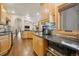 Open kitchen with stone backsplash, stainless steel appliances, and wooden cabinets at 20190 Deer Shadow Way, Monument, CO 80132