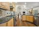 Charming kitchen with wooden cabinets, a stone backsplash, and stainless steel appliances at 20190 Deer Shadow Way, Monument, CO 80132