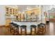 Kitchen featuring an island with seating, wooden cabinets, and stone countertops at 20190 Deer Shadow Way, Monument, CO 80132