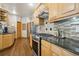Charming kitchen with granite countertops, stainless steel appliances, and beautiful hardwood floors at 20190 Deer Shadow Way, Monument, CO 80132